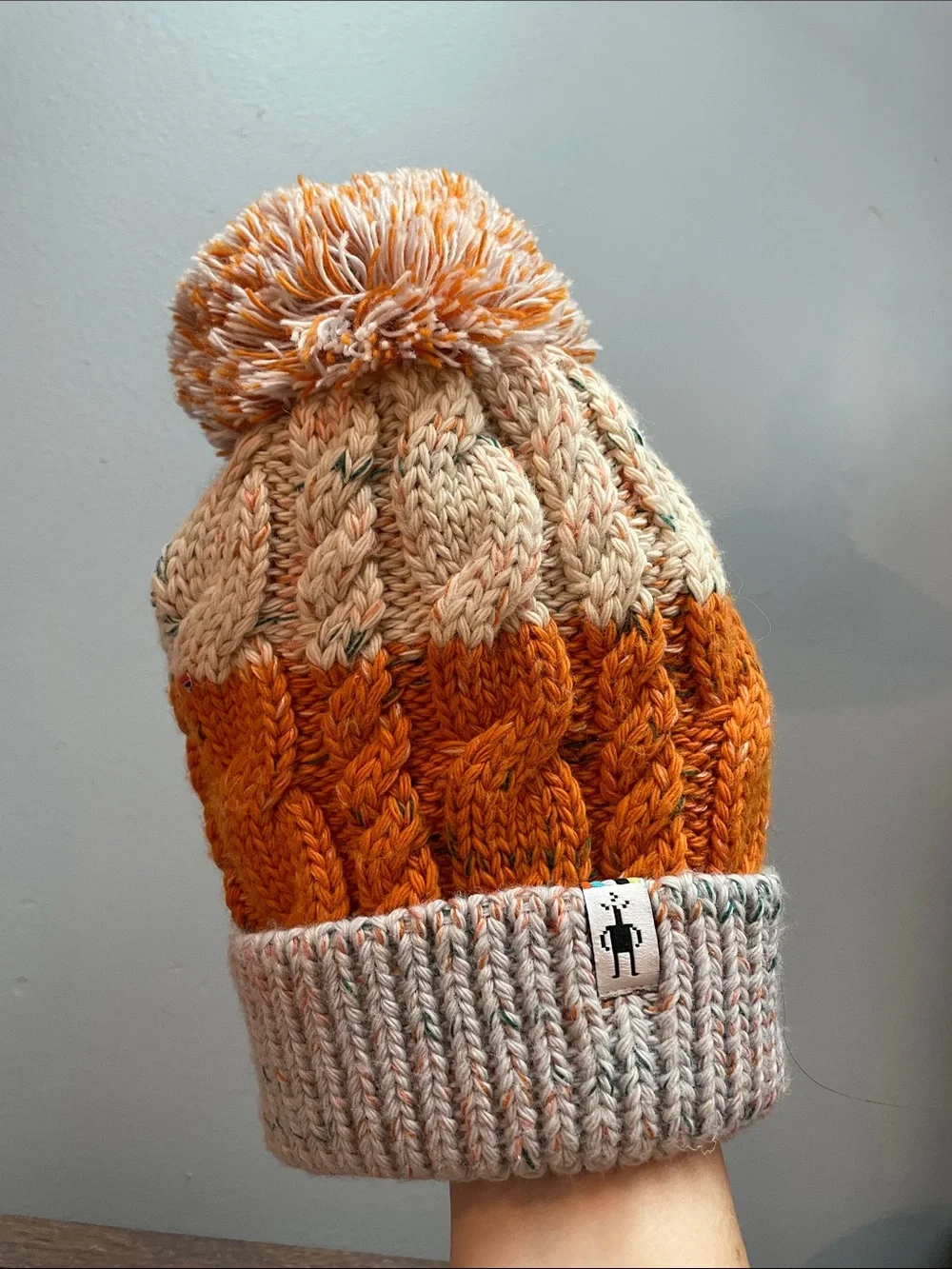 Smartwool Kids Isto Retro Cable Knit Pom Beanie in Orange and Cream and Gray